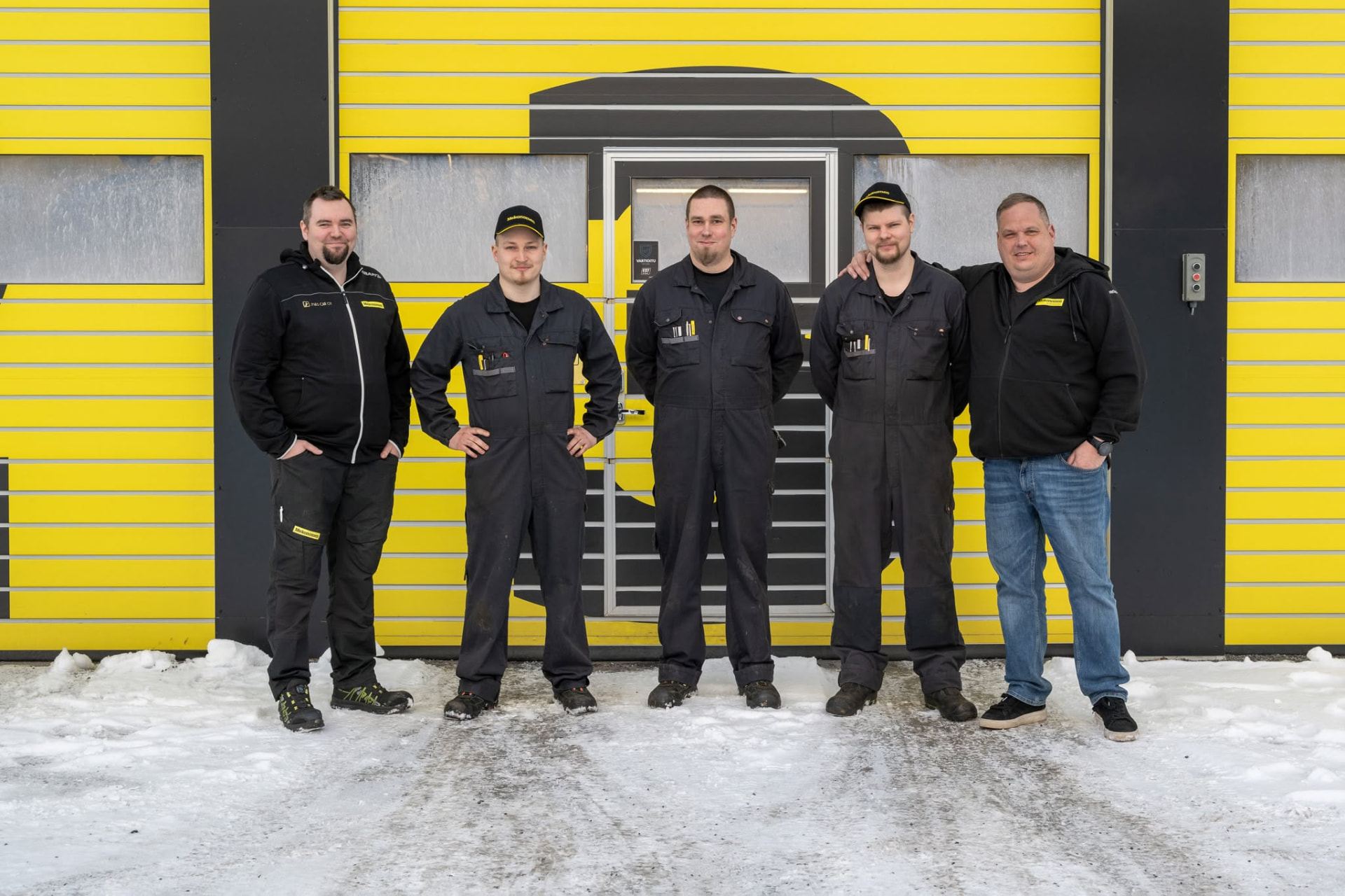 Members of the association standing outside their workshop premises in winter